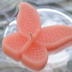 set of eight coral reef butterfly shaped floating wedding candles for reception centerpieces