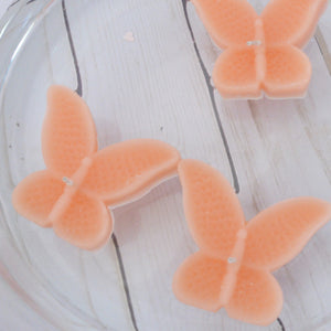 set of eight peach butterfly shaped floating wedding candles for reception centerpieces