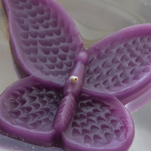 set of eight plum purple butterfly shaped floating wedding candles for reception centerpieces