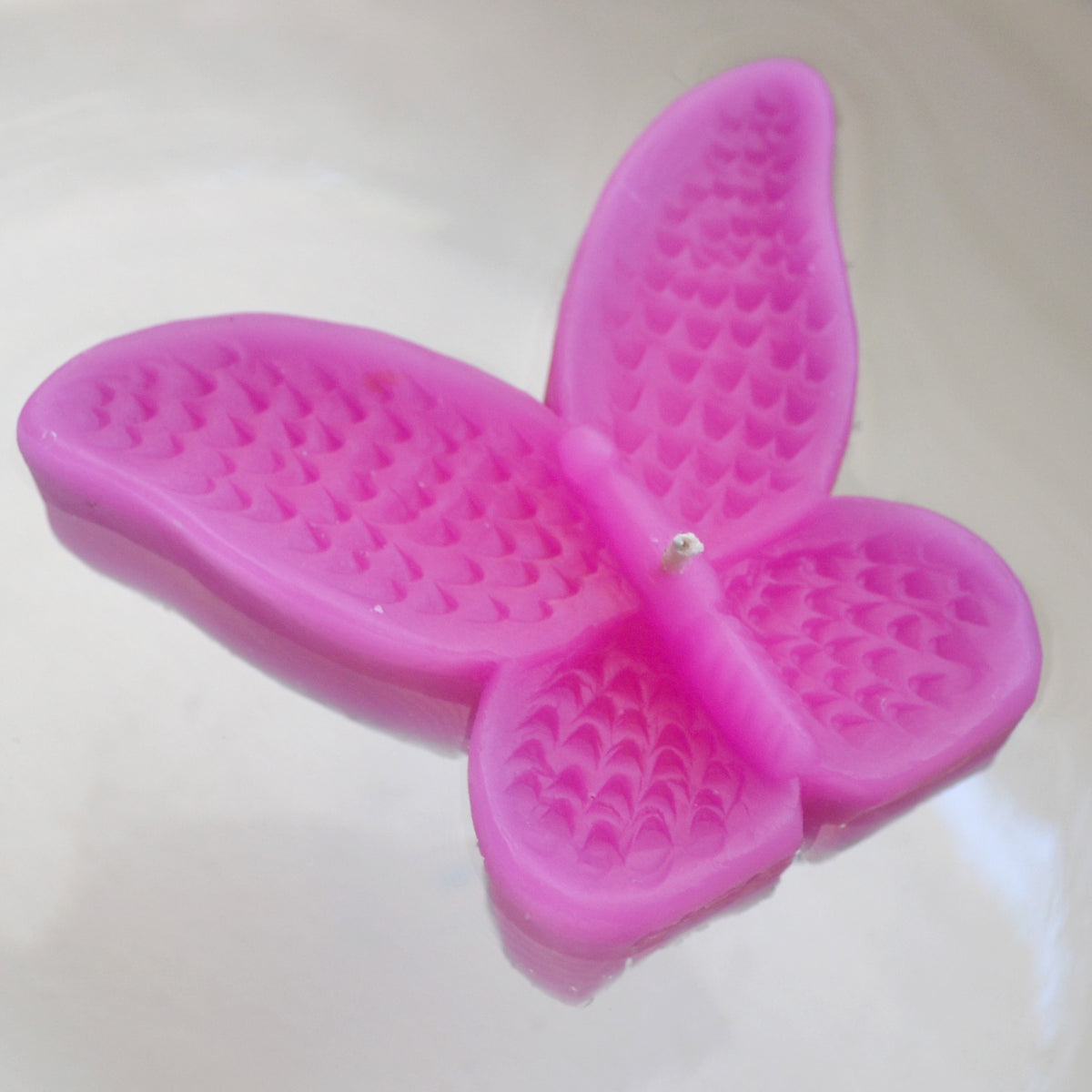 set of eight begonia pink butterfly shaped floating wedding candles for reception centerpieces