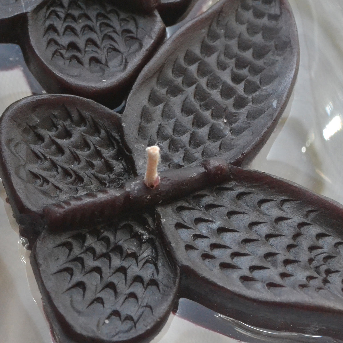 set of eight black butterfly shaped floating wedding candles for reception centerpieces