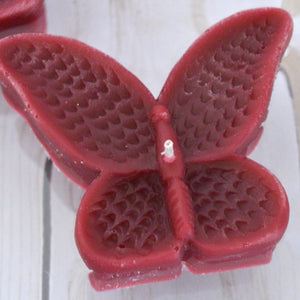 set of eight burgundy butterfly shaped floating wedding candles for reception centerpieces