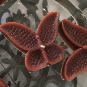 set of eight chocolate brown butterfly shaped floating wedding candles for reception centerpieces