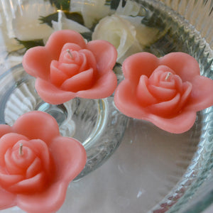 coral reef colored rose shaped floating candle for wedding reception centerpieces