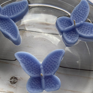 set of eight dusty blue butterfly shaped floating wedding candles for reception centerpieces