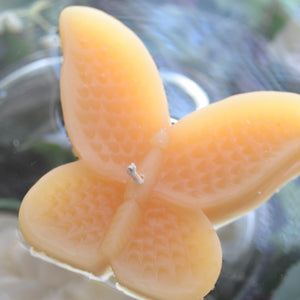 set of eight golden honey butterfly shaped floating wedding candles for reception centerpieces