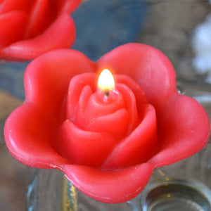 guava colored rose shaped floating candle for wedding reception centerpieces