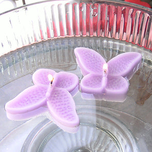 set of eight lavender light purple butterfly shaped floating wedding candles for reception centerpieces