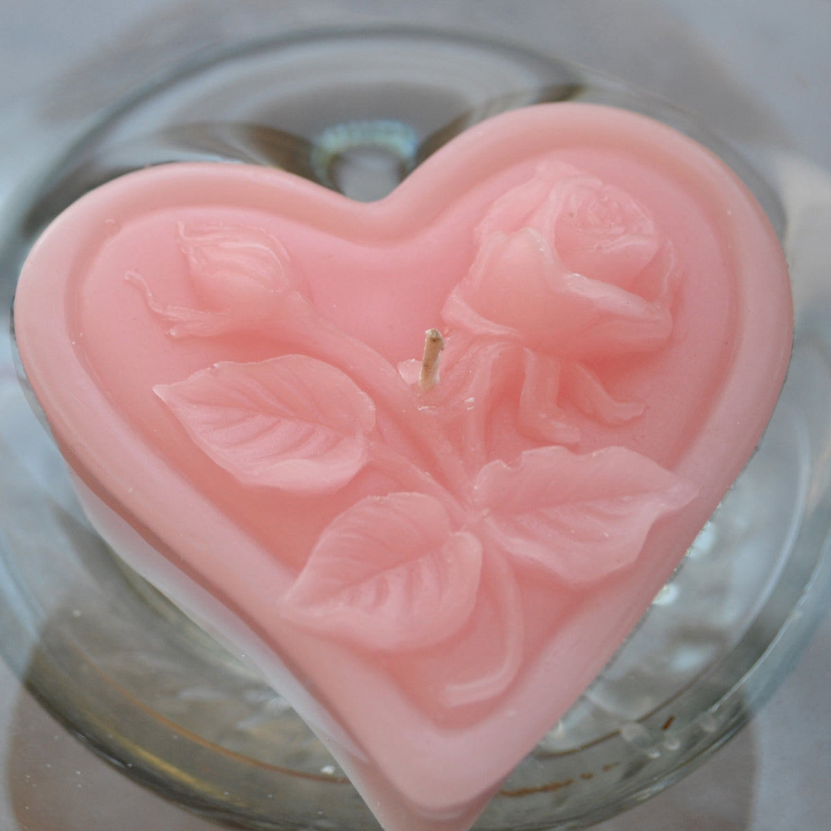 light pink blush floating heart candle with rose motif for wedding reception centerpieces