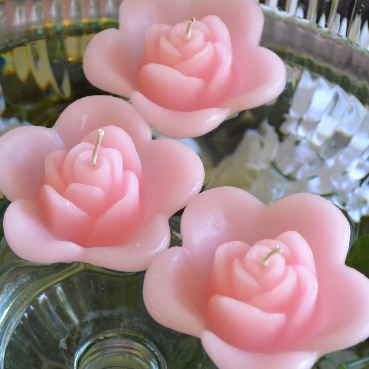 light pink blush colored rose shaped floating candle for wedding reception centerpieces