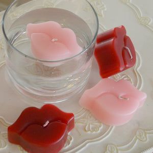 red and pink lip shaped floating candles scented in black raspberry vanilla