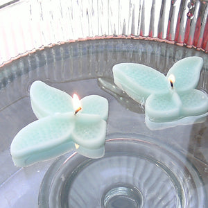 set of eight mint green butterfly shaped floating wedding candles for reception centerpieces