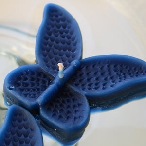 set of eight navy blue marine butterfly shaped floating wedding candles for reception centerpieces
