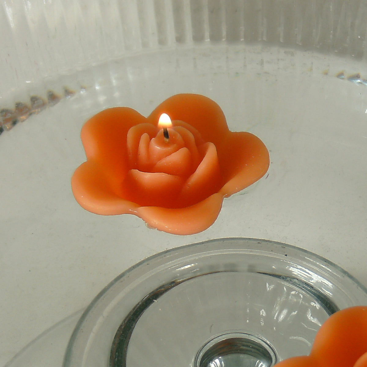 tropical orange colored rose shaped floating candle for wedding reception centerpieces