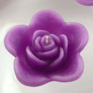 raspberry purple colored rose shaped floating candle for wedding reception centerpieces