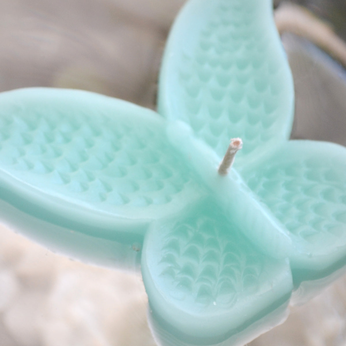 set of eight spa blue butterfly shaped floating wedding candles for reception centerpieces