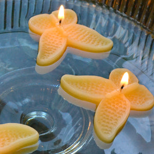 set of eight sun yellow butterfly shaped floating wedding candles for reception centerpieces