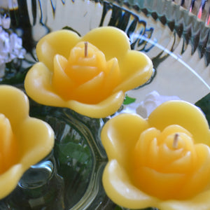 sun yellow colored rose shaped floating candle for wedding reception centerpieces