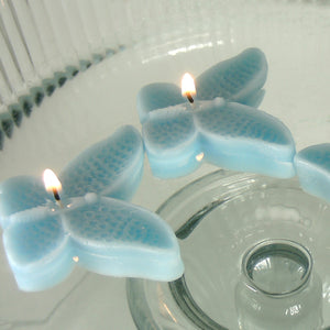 set of eight turquoise butterfly shaped floating wedding candles for reception centerpieces