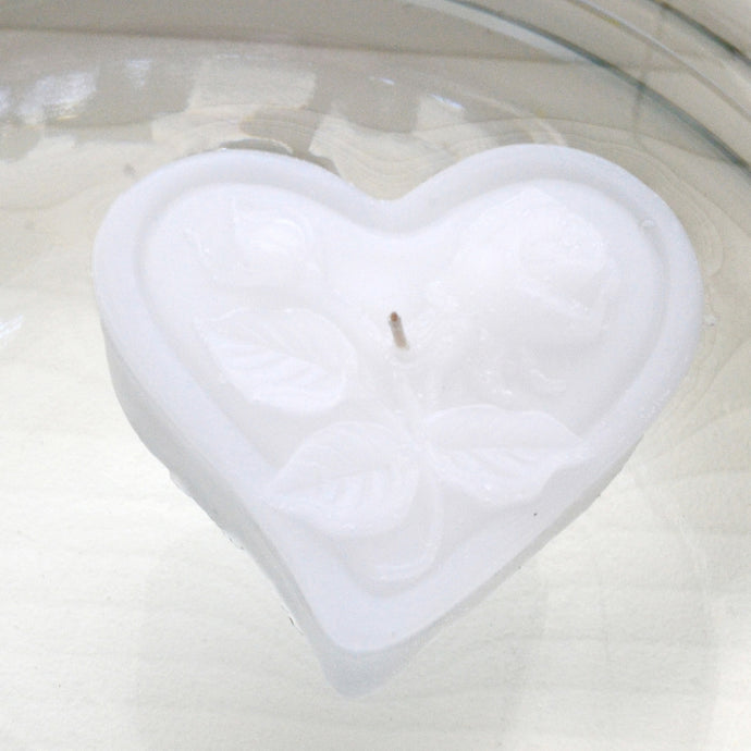 white heart shaped floating candles with rose motif for wedding reception centerpieces